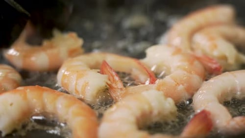 Chef is Frying Shrimps on a Pan