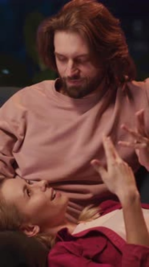 Loving Couple Laughing Together at Home at Night