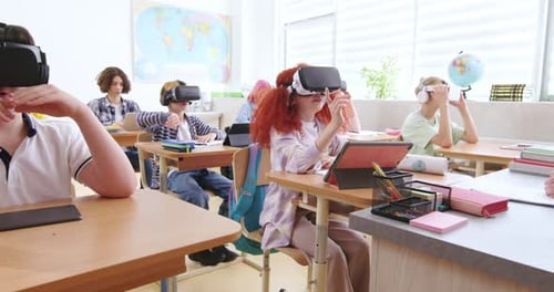 Smart Pupils Wearing VR Headsets and Studying with Future Technologies at Classroom Excited Boys and