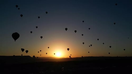 Hot Air Balloons Flying at Desert Sunrise