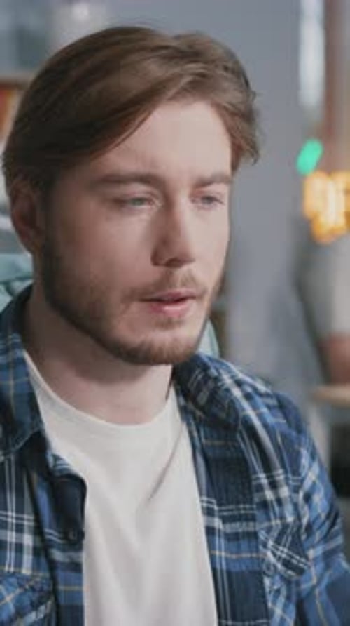 Man in plaid shirt works in modern office