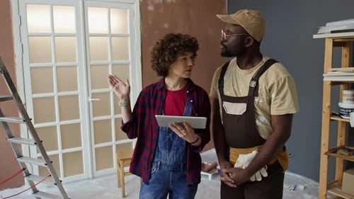 People Planning Room Renovation with Tablet