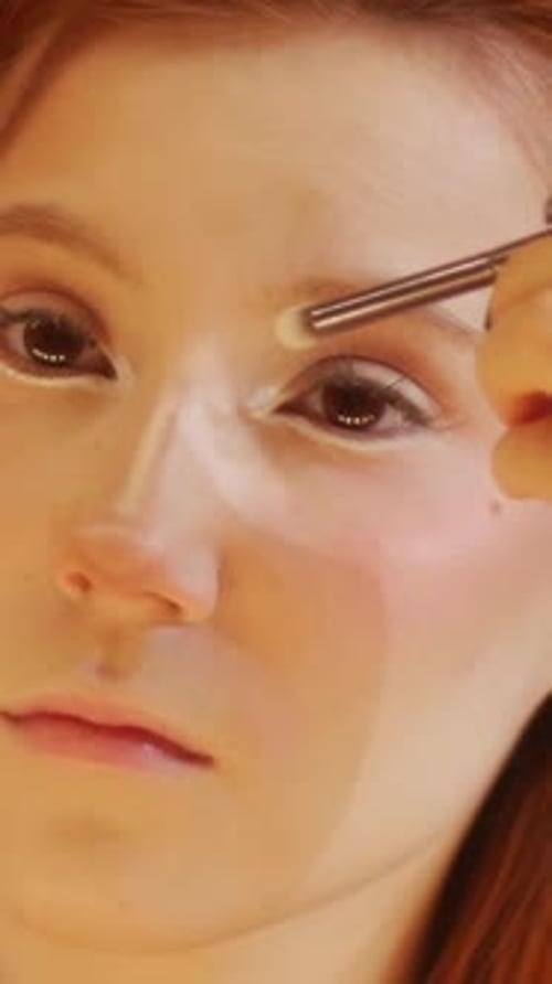 A Cute Ginger Girl Doing Eye Makeup