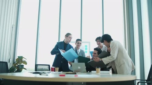 Diverse Business Team Collaborating on Project in Modern Office