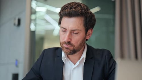 Focused Businessman Working in a Modern Office Environment