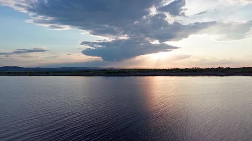 Black Sea with Cool Water Extends Beyond the Horizon Under a Sky with Clouds and a Dawn Sun