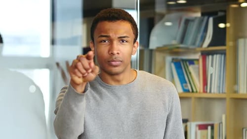 Young Adult Points Index Finger at Viewer