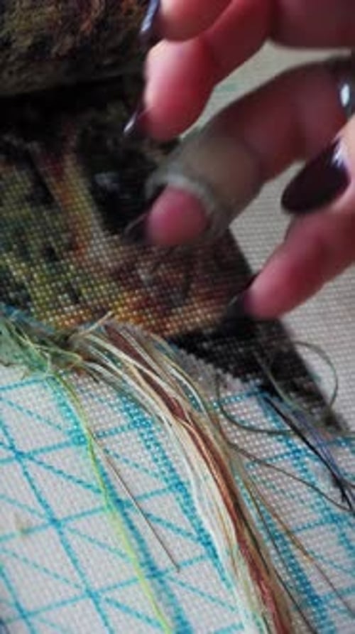 Close up of female hand making embroidery picture of nature. Vertical video
