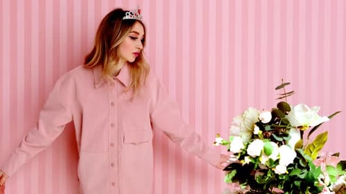 Blonde Woman Posing With Flowers and a Crown