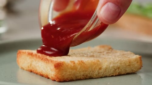 Adding Red Sauce Jam on Fried Bread Closeup Cooking Sandwich at Cafe Pouring Tomato Sauce on Top