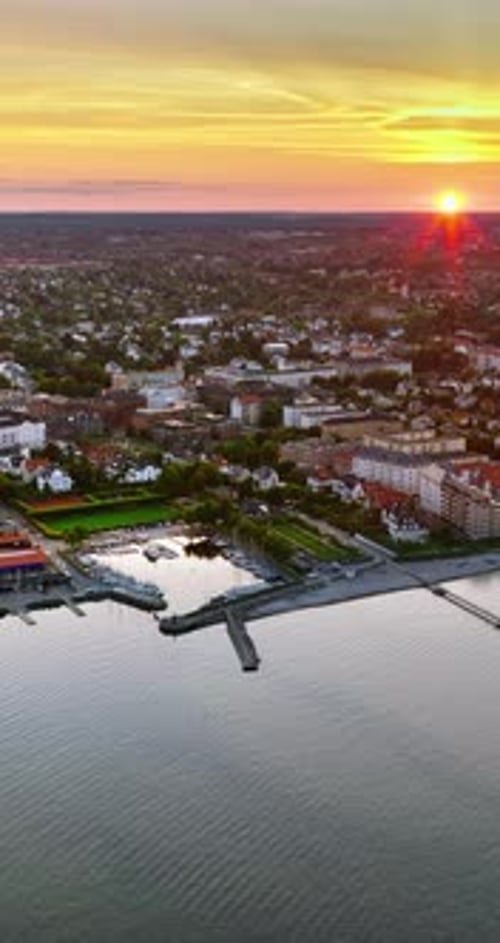 Aerial drone view of Osterbo Nord, Nordhavn harbour area at the coast of the Oresund at sunset. Vert