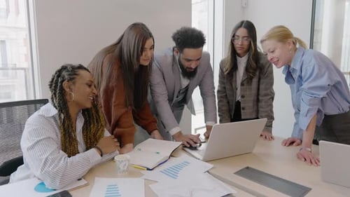 A Diverse Team Actively Collaborating Together in a Modern and Dynamic Office Environment