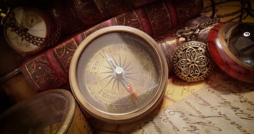 Vintage style travel and adventure. Vintage old compass and other vintage items on the table.