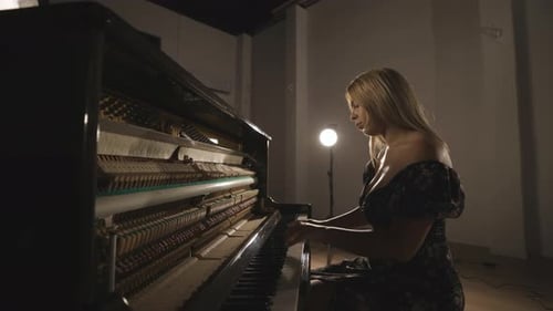 Caucasian Attractive Blond Woman Musician Playing Practicing Piano Instrument in Studio, Open