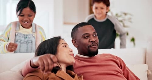Loving Family Relaxing Together on Couch at Home