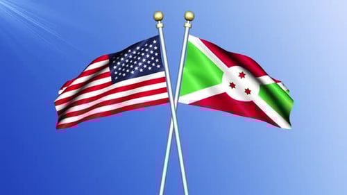 Waving Flags of United States and Burundi Against Blue Sky