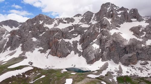 Majestic Snowy Mountains with Alpine Lake Aerial View