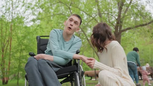 Young Couple Holding Hands in a Green Park