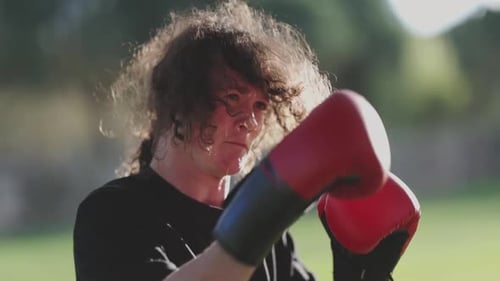 Young Athlete Practicing Boxing Punches in a Park