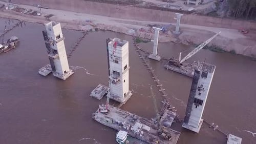 Aerial View of the Factory at the edge of the river carrying grains in a freighter