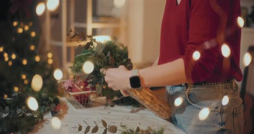 Woman Preparing Christmas Wreath Garland For Christmas Holidays