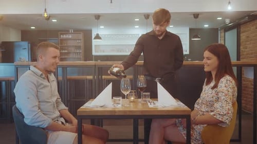 Young couple enjoying romantic dinner in a modern restaurant.