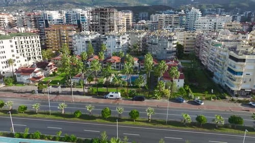 Aerial Video Aerial Perspective of a Vintage Villa Complex with Lush Greenery and Scenic Backdrops