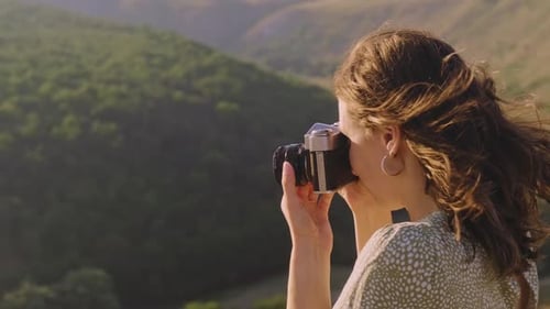 Woman Photographs Landscape with Vintage Camera