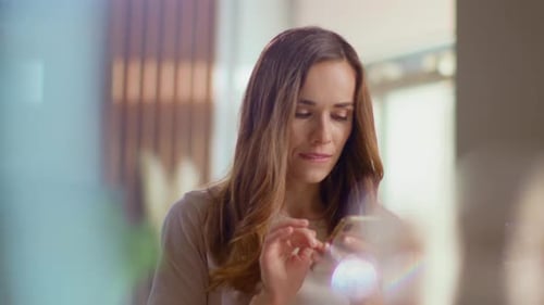Woman using her smartphone indoors in close up shot