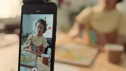 Female Blogger Recording Painting Tutorial on Smartphone