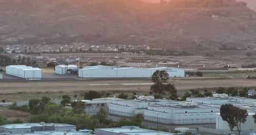 Small Plane on Airport Runway at Sunrise