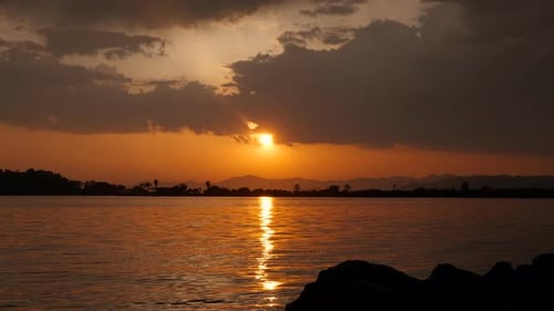 Orange Nightfall Under River Silhouette