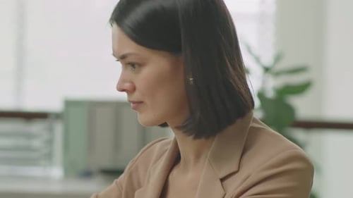 Businesswoman Using Laptop at Office Desk