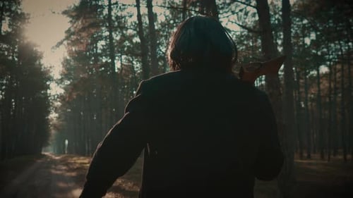 Maniac Wearing Coat and Wig for Being Unrecognizable Walking with Axe in Forest Danger Killer