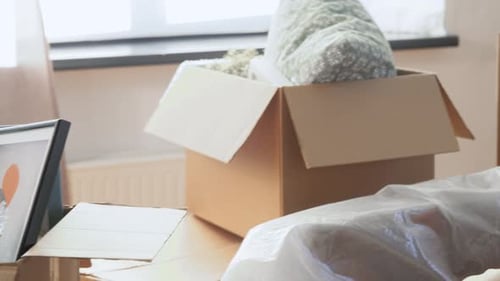 Moving, People and Real Estate Concept - Happy Smiling Woman with Boxes