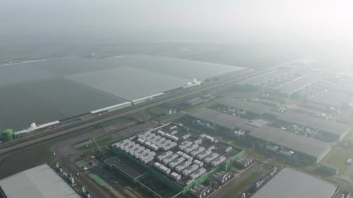 Drone shot of a large scale data center facility in a modern technology park.