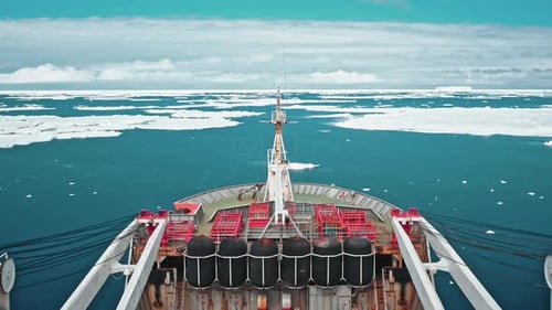 Ship Travels Through Icy Waters Aerial Shot