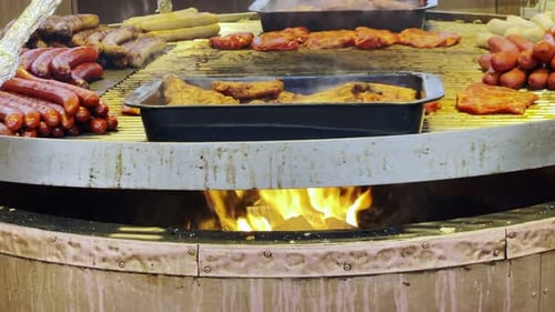 Sizzling Sausages and Meats on Open Fire Barbecue Grill