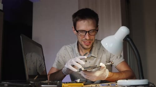Master in Glasses examine attentivement la carte mère et se réjouit du problème