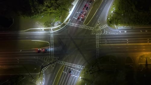 Top View of Large Multilane Road Intersection with Traffic Lights and Moving Cars and Trucks at