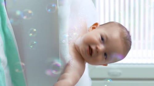 Happy Baby Enjoys Bath Time with Soap Bubbles