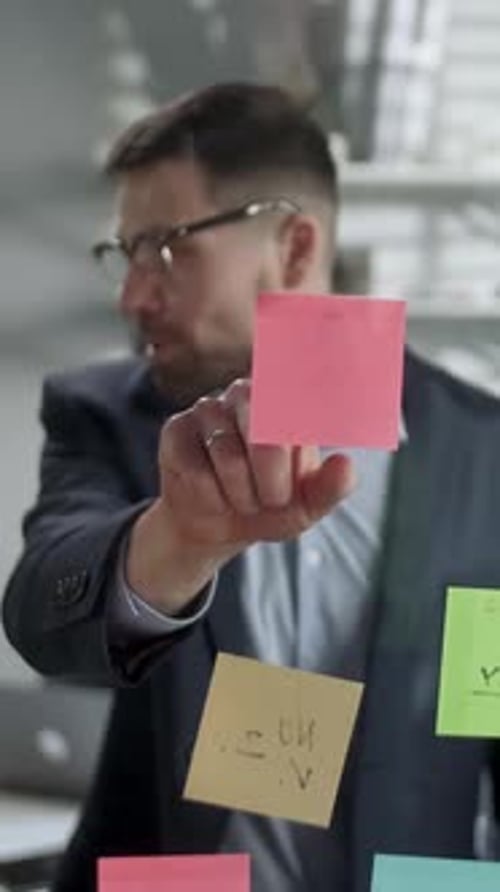 Business Professionals Brainstorming with Sticky Notes in Office