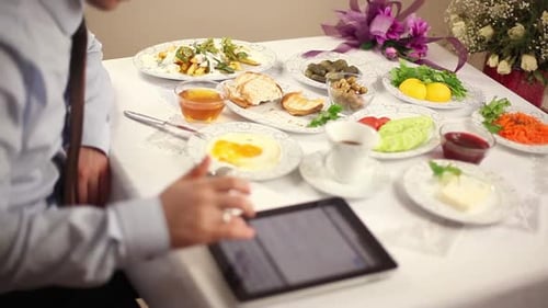 Busy Businessman at Breakfast Table