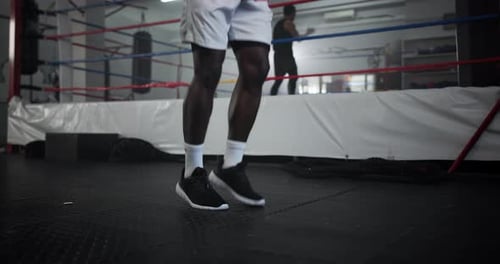 Legs, man and skipping for fitness at gym for wrestling match, workout and professional competition