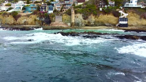 Aerial View of Pirate Tower Landmark of Victoria Beach and Pacific Ocean Waves Breaking Under Cliffs