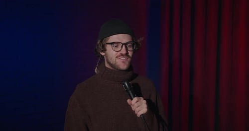 Positive Young Comedian Speaking with His Audience at Stage Stand Up Show in Bar Man Comic Speaking