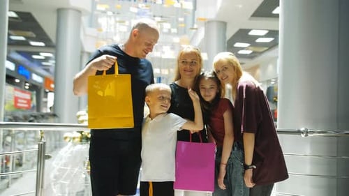 Caucasian Family with Three Kids Spending Weekend in Shopping Mall