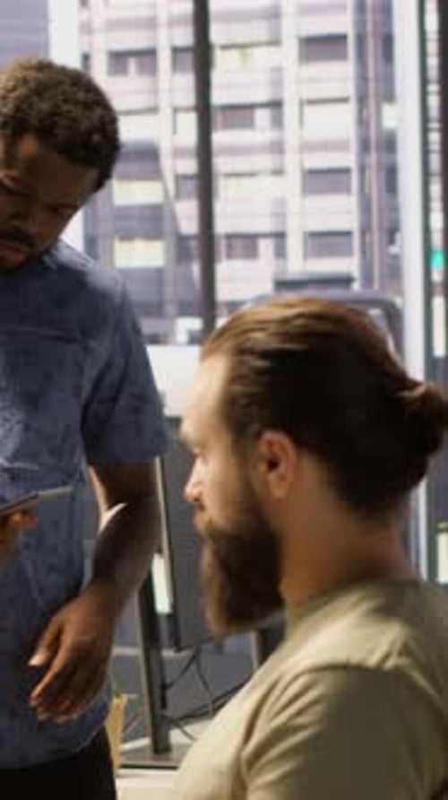 Coworkers in Office Collaborate Over Data