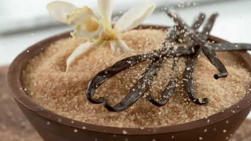 Raw Sugar Falling Onto Vanilla Beans in . on Phantom