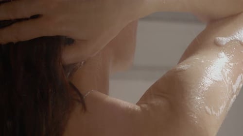 Woman Washing in Shower with Soap and Water